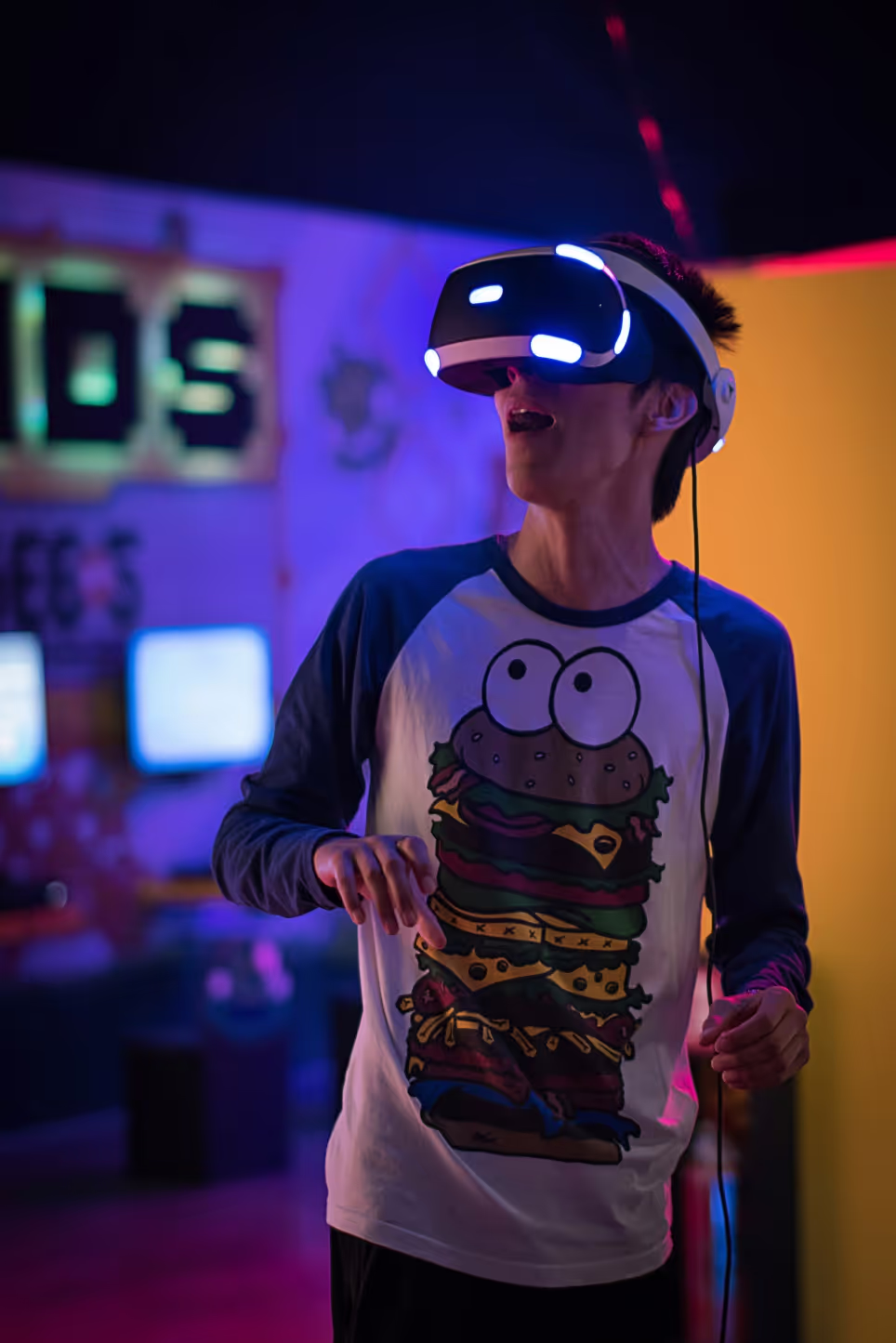 A masculine person with a VR helmet on, seemingly amazed by  what is displayed in the virtual world.